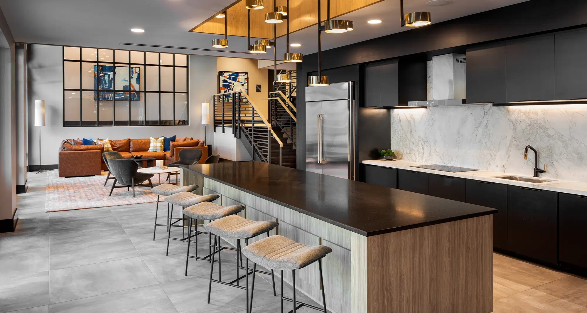 Luxurious apartment lounge with an open kitchen, leather seating, and modern industrial design